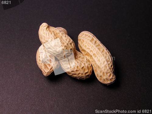Image of  3 peanuts over the black background