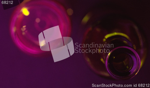 Image of wine bottle with glass behind