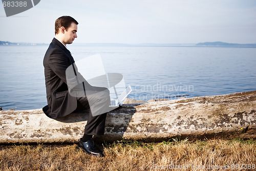 Image of Caucasian businessman with laptop