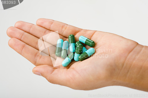 Image of woman's hand holding antibiotics