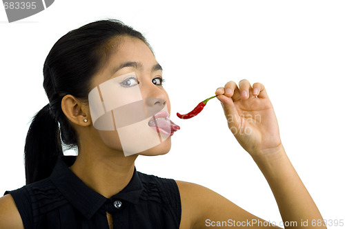 Image of woman licking hot chili pepper