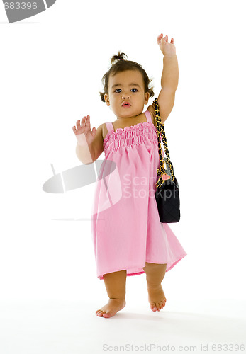 Image of little thai-english girl walking with purse