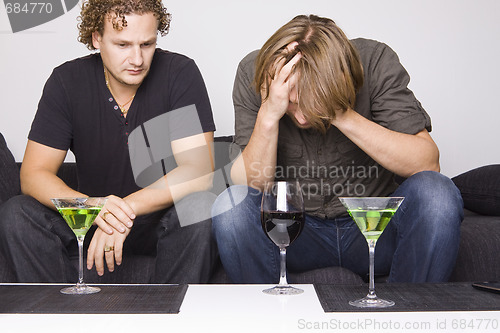 Image of two friends drinking at home