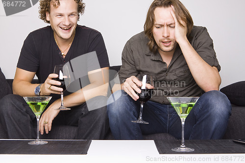 Image of two friends drinking at home