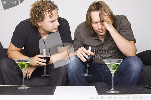 Image of two friends drinking at home