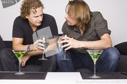 Image of two friends drinking at home