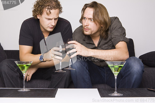 Image of two friends drinking at home