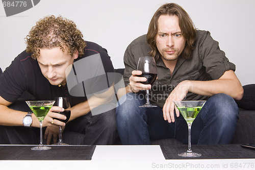 Image of two friends drinking at home