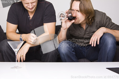 Image of two friends drinking at home