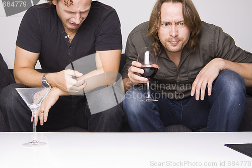 Image of two friends drinking at home