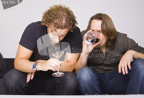 Image of two friends drinking at home