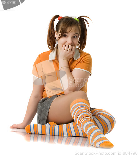 Image of Adult girl with a two pony-tail sits on a floor