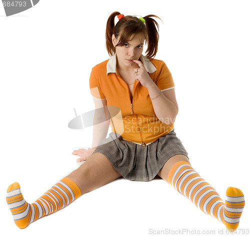 Image of Adult girl with a two pony-tail sits on a floor