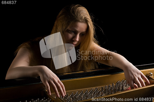 Image of Girl behind a grand piano