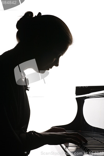 Image of beautiful girl playing the piano