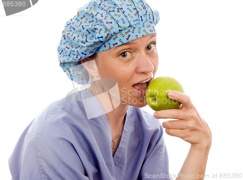 Image of nurse medical person eating granny smith apple