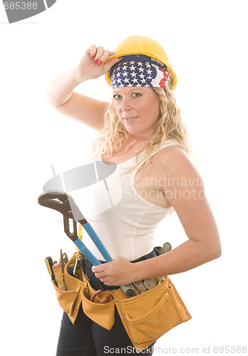 Image of attractive woman contractor with tools and hard hat helmet