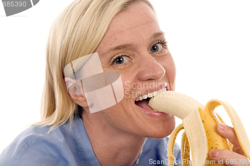 Image of nurse medical person eating banana