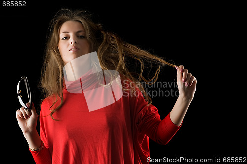 Image of beautiful girl holds sunglasses in a hand