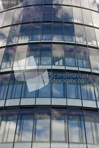 Image of clouds reflection on office building