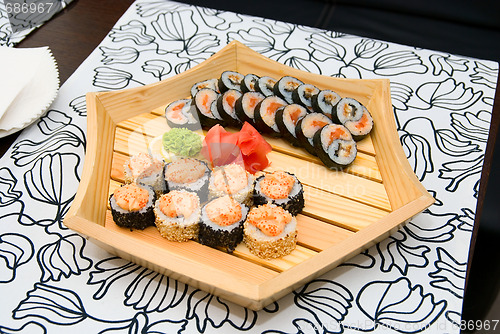 Image of sushi on wood plate