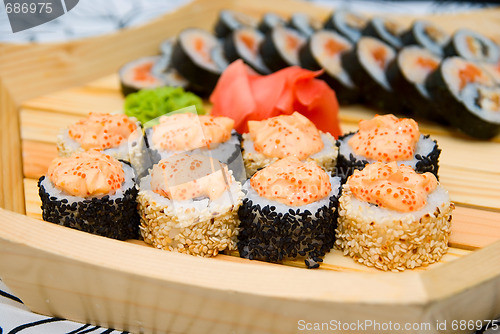 Image of sushi on wood plate