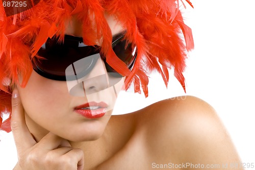 Image of woman with red feather wig and sunglasses