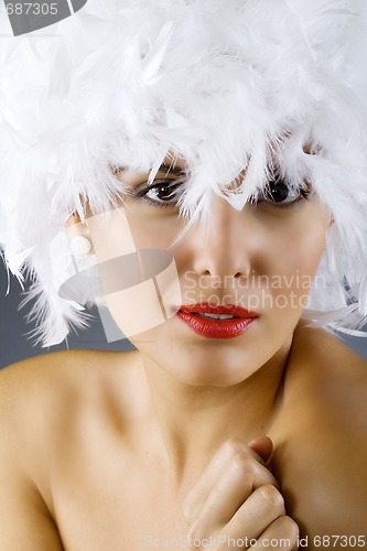 Image of attractive woman wearing a white feather wig