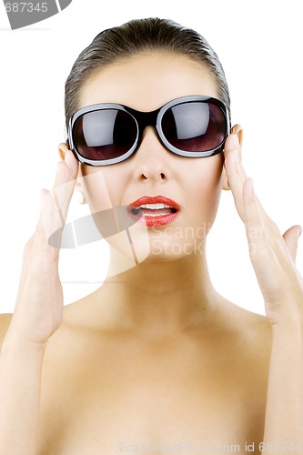 Image of woman holding her sunglasses