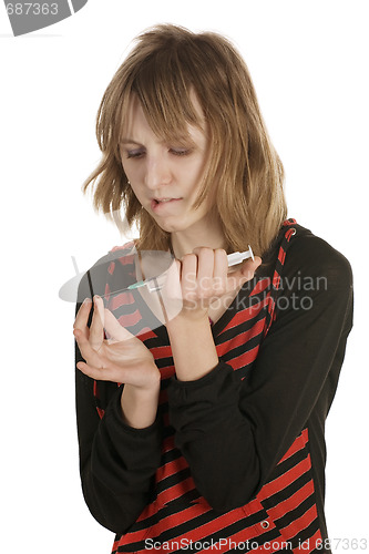 Image of girl pricks a finger a syringe