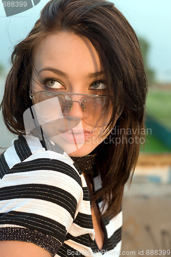 Image of Portrait of the attractive young woman outdoors
