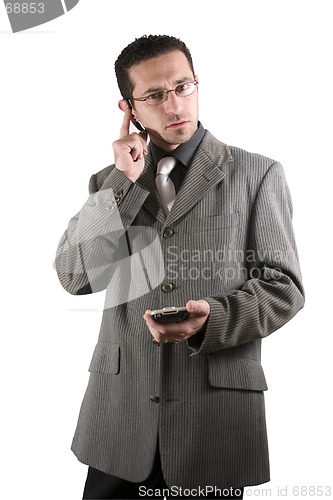 Image of Businessman on the PDA phone with an ear piece