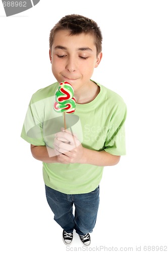 Image of Boy holding a sweet yummy Christmas candy