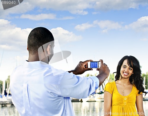 Image of Woman posing for picture near boats