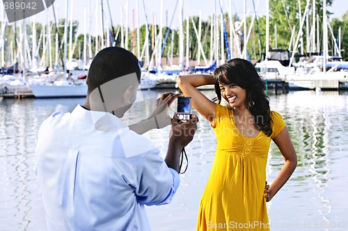 Image of Woman posing for picture near boats