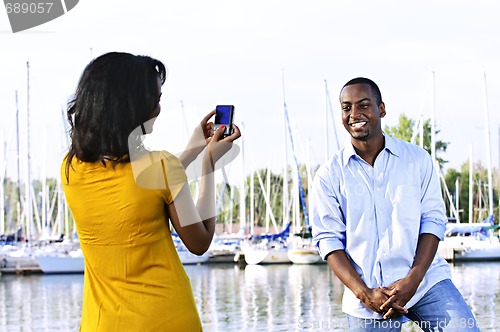 Image of Man posing for picture near boats