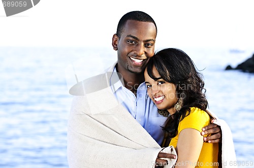 Image of Happy couple sharing blanket