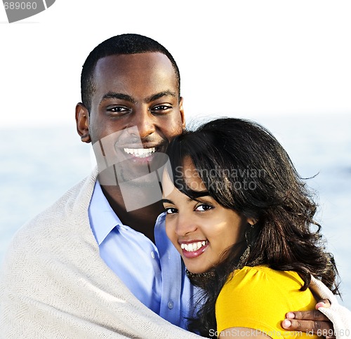 Image of Happy couple sharing blanket