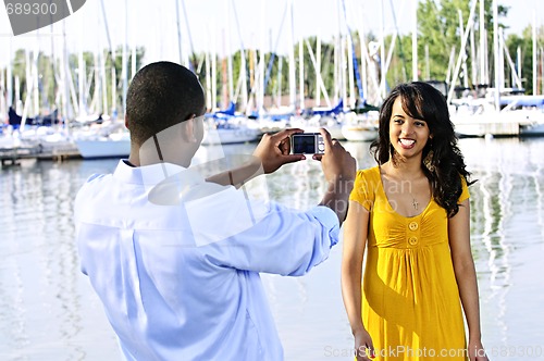 Image of Woman posing for picture near boats