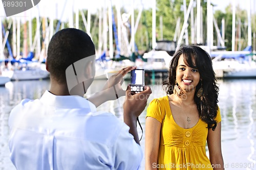 Image of Woman posing for picture near boats