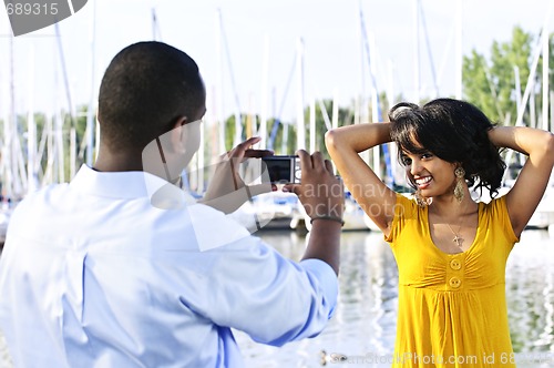 Image of Woman posing for picture near boats