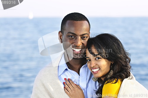 Image of Happy couple sharing blanket