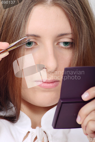 Image of The attractive girl doing a make-up