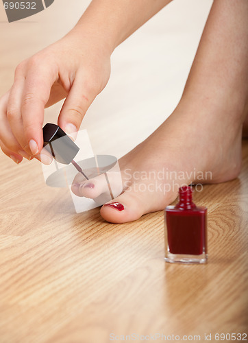 Image of Applying red nail polish 