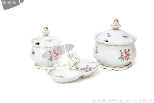 Image of Two white porcelain sugar basins and double jam dish with roses isolated