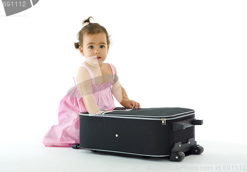 Image of cute little girl with luggage