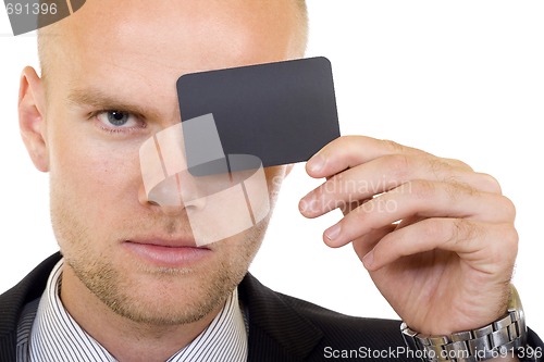 Image of Young businessman with blank card in his hand