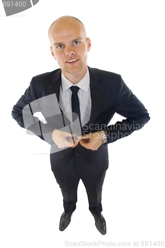 Image of  picture of a young businessman buttoning his coat