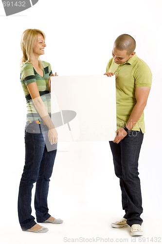 Image of young couple presenting a blank board 