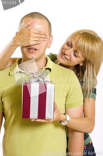 Image of woman covering her husband's eyes to surprise him